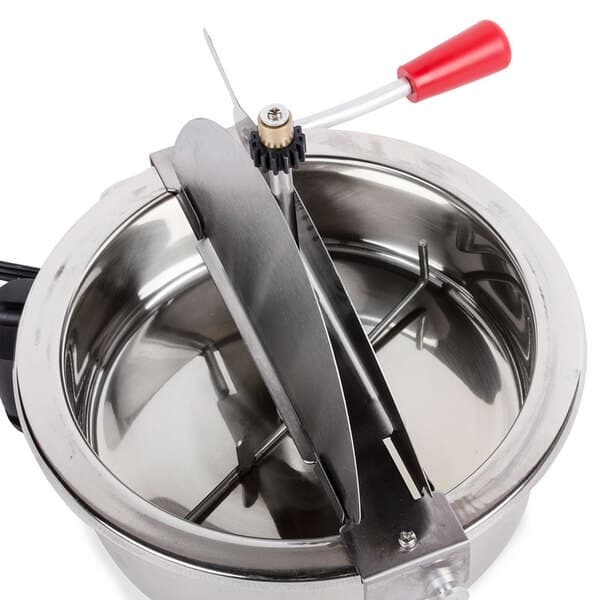 A stainless steel kettle with a red handle.