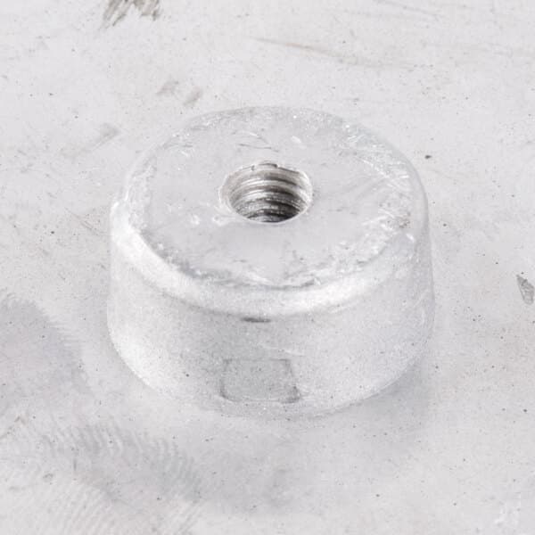 A round silver metal grid with a screw.