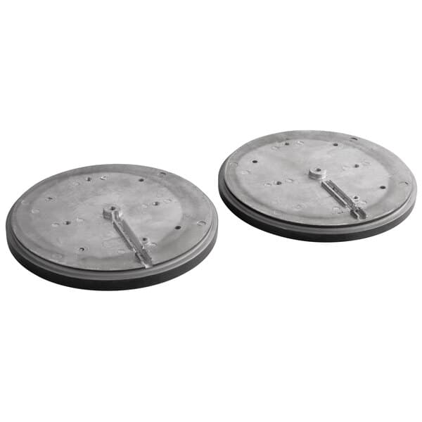 Two round metal plates with holes on them.