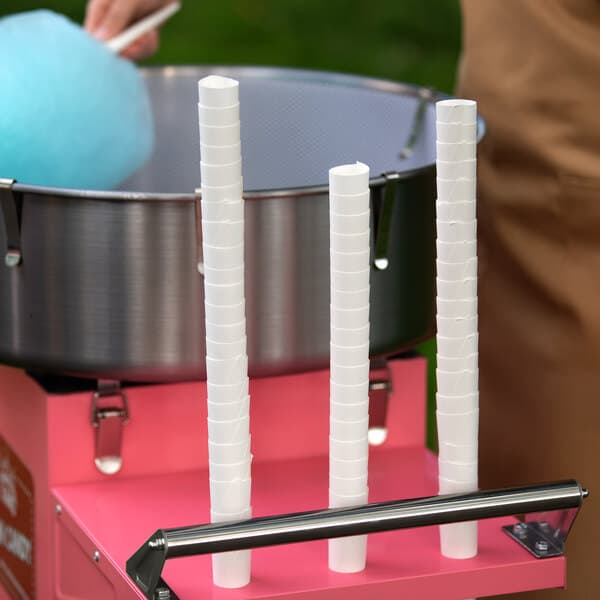 A person holding a white Carnival King cotton candy cone.