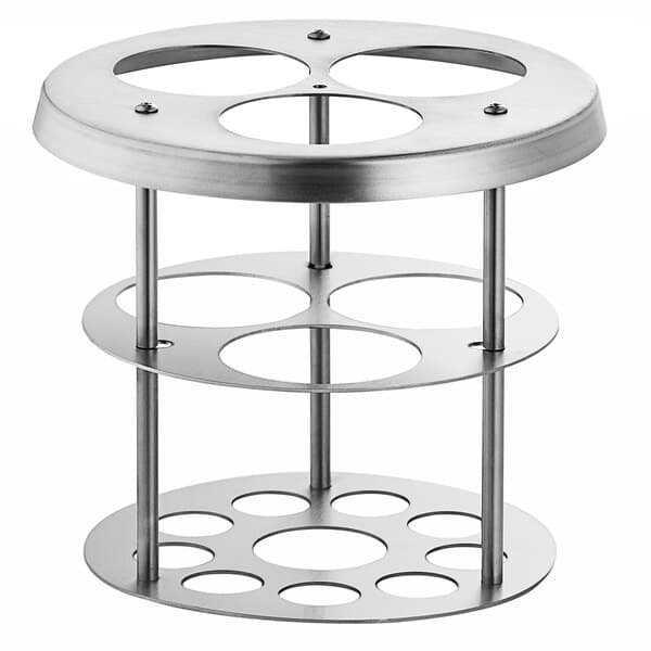 A stainless steel circular holder with four holes for Carnival King sauce bottles.