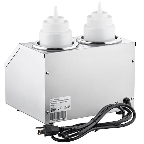 A silver Carnival King sauce warmer with two white containers and a silver machine with white plastic bottles.