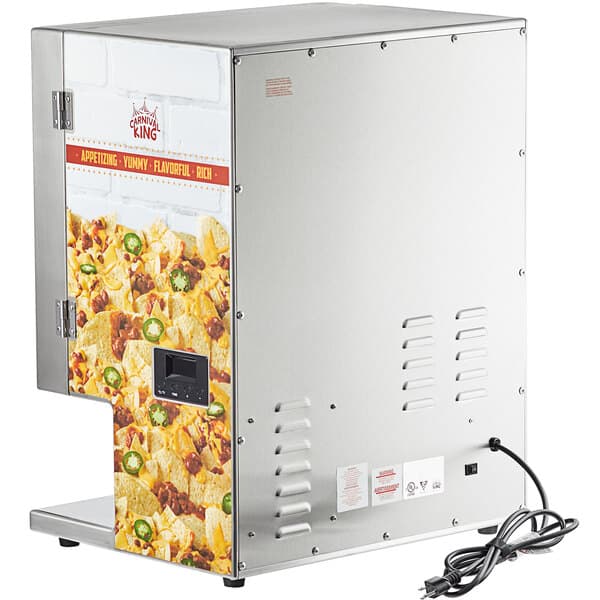 A Carnival King stainless steel dual peristaltic cheese sauce and chili dispenser on a counter in a stadium concession stand.