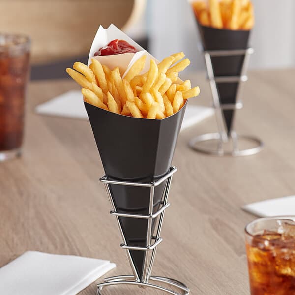 A black Carnival King cardboard fry cone filled with french fries on a table.