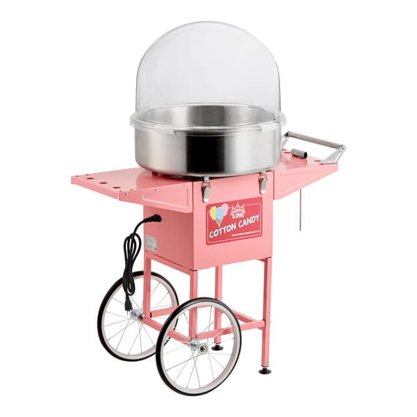 A pink cotton candy machine with a stainless steel bowl, clear dome cover, and wheeled cart.
