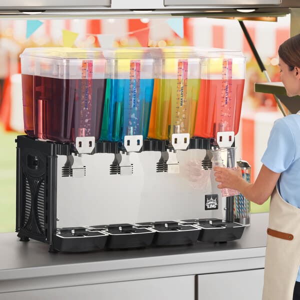 A quadruple 5-gallon bowl refrigerated beverage dispenser with four separate containers holding different colored drinks.