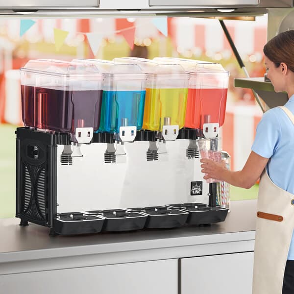 A quadruple 3-gallon bowl refrigerated beverage dispenser with four separate containers holding different colored drinks.