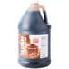 A jug of Carnival King Cola Slushy Syrup with a lid.