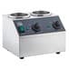 A silver and black stainless steel Carnival King sauce topping bottle warmer with two bowls on a counter.
