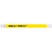 A neon yellow and white Tyvek wristband with black text reading "OVER 21"