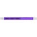 A purple Carnival King Tyvek wristband with black text reading "STAFF"
