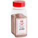 A plastic container with a red lid filled with brown chili seasoning.