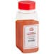 A plastic container with a red lid of Carnival King Smokehouse Popcorn Seasoning with red powder inside.