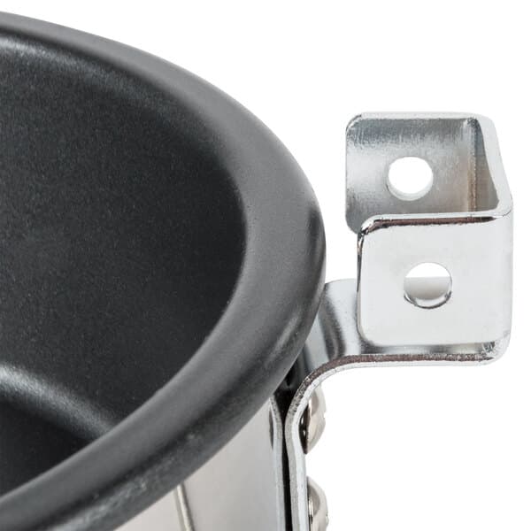 A close-up of a metal kettle with a handle.