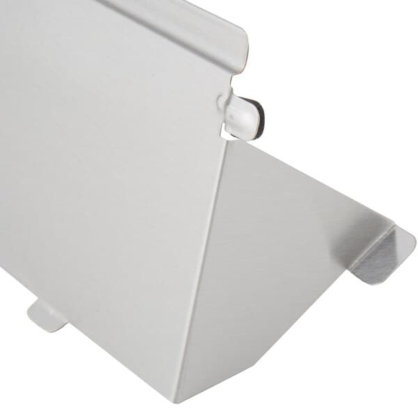 A silver metal shelf with a metal clip.