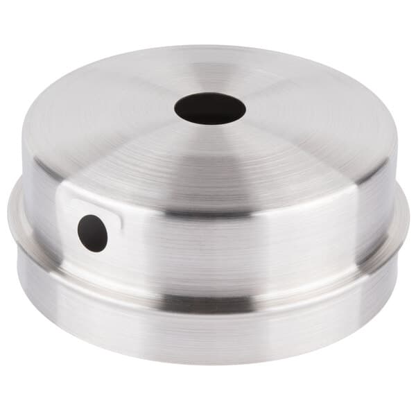 A silver round metal lid with a hole in the center.