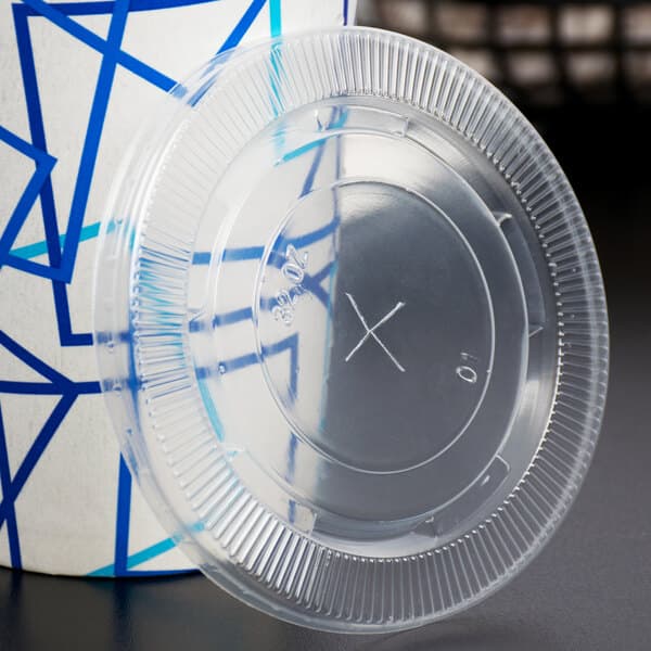 A clear plastic Carnival King cold cup with a clear plastic flat lid with a straw slot.