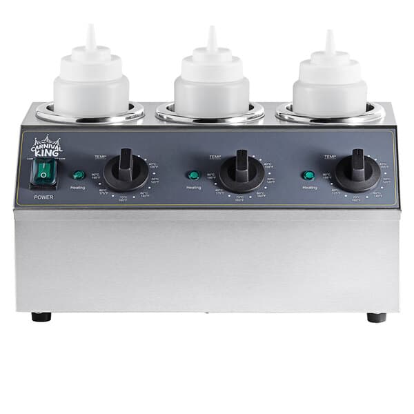 A silver and black Carnival King sauce warmer on a counter with white squeeze bottles.