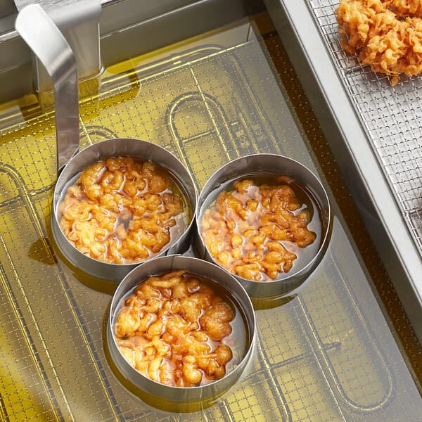 A Carnival King Triple Mini Funnel Cake Mold Ring with brown liquid in the bowls.