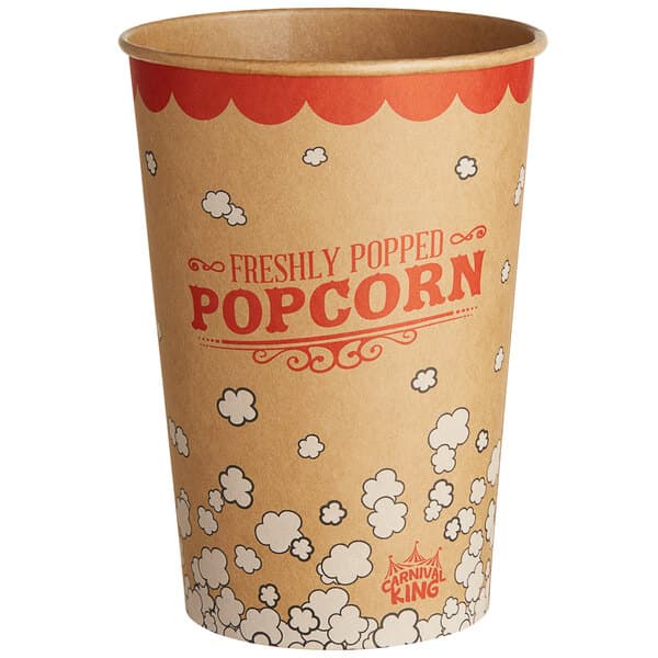 A brown and red Carnival King paper cup with white and red text filled with popcorn.