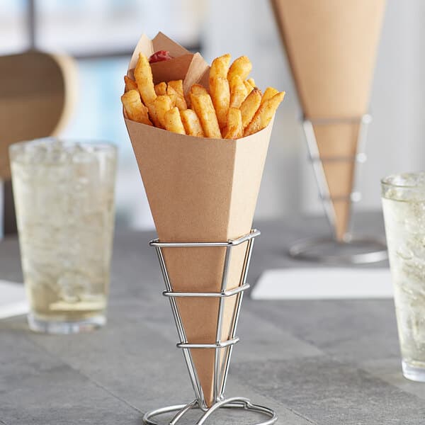 A Carnival King Kraft paper cone filled with french fries on a table.