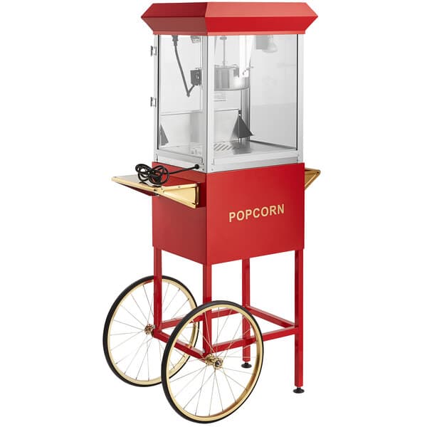 A red and gold Carnival King Kettle Corn popcorn machine on a stand with wheels.