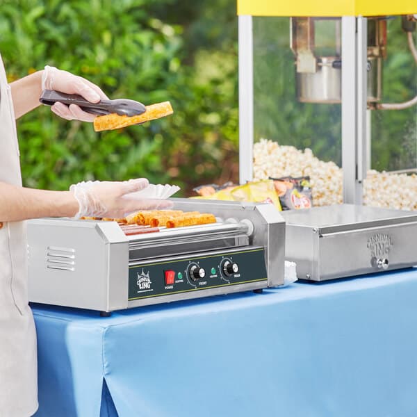 a hand holding food on a machine