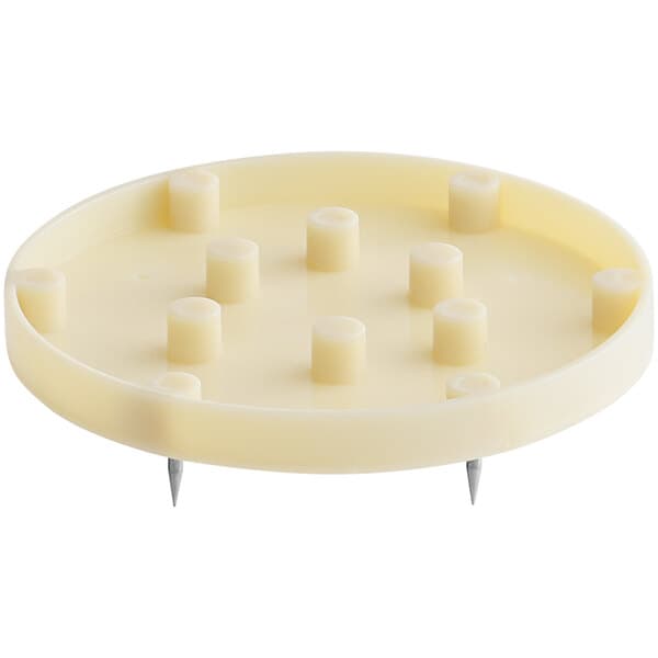 A white circular plate with nail claws on it.