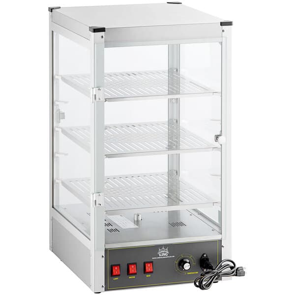 A Carnival King countertop warmer with a glass door and shelves.
