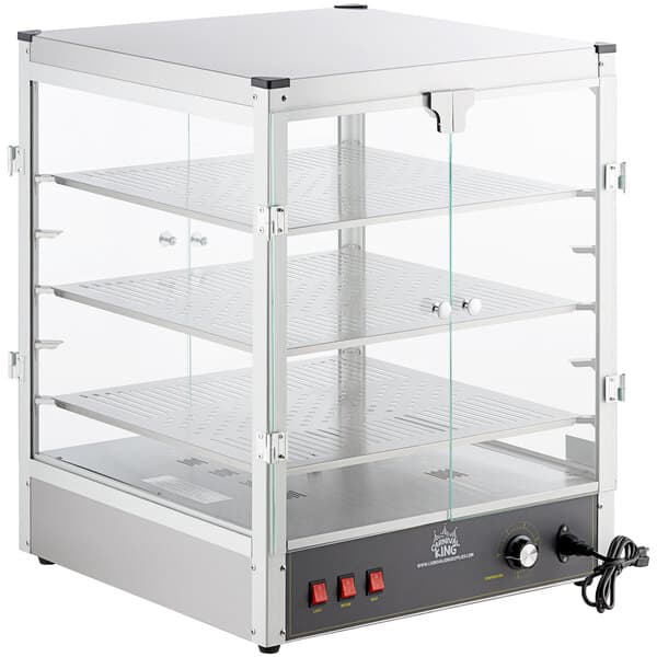 A Carnival King countertop warmer with a glass door and shelves.