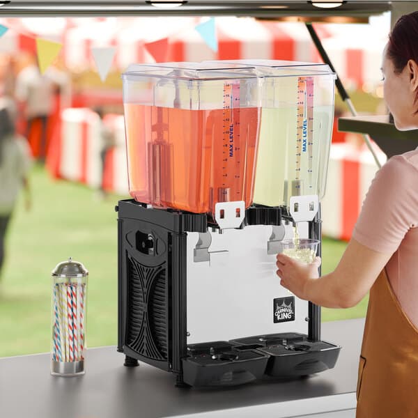 A double 5-gallon refrigerated beverage dispenser with two clear containers for serving cold drinks.