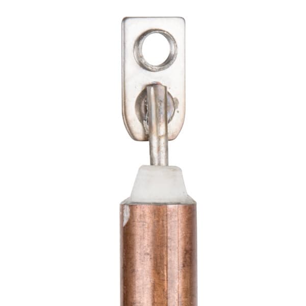 A close-up of a metal heating element with a copper tube.