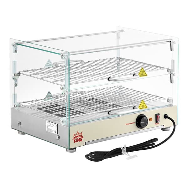 A Carnival King silver glass countertop food warmer with metal racks inside.