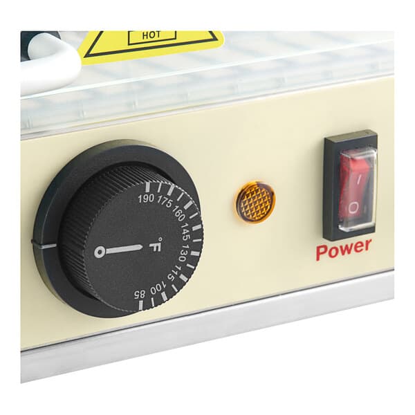 A white curved Carnival King hot food display case with a black and yellow temperature dial.