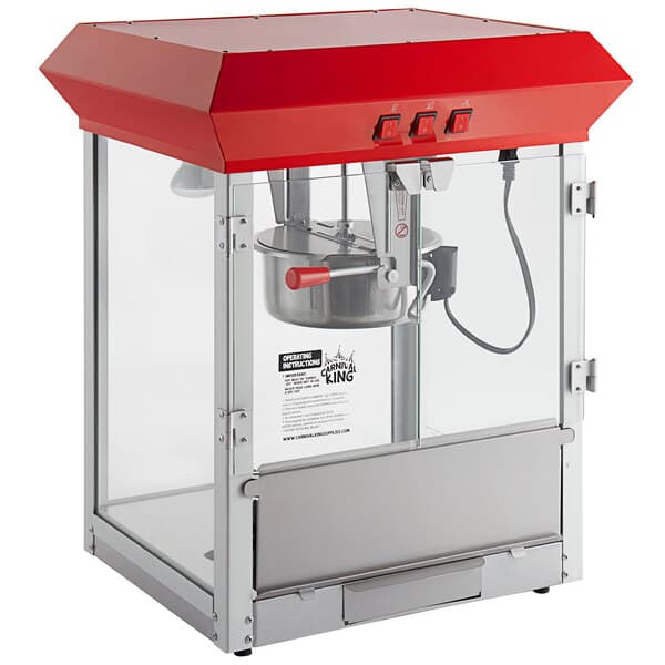 A red and silver Carnival King commercial popcorn machine with a red lid.