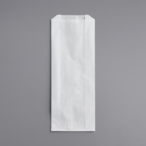 A white Carnival King paper hot dog bag on a gray surface.